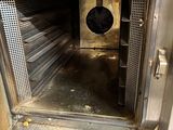 a metal oven with a door open in a kitchen