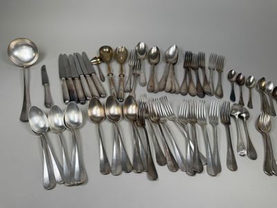 a lot of spoons and forks on the table