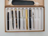 a box with pens and a pen holder inside of it