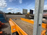 a flatbed trailer that is parked in the lot