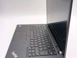 a black laptop with a red button on the keyboard