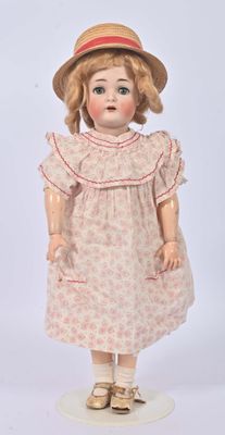 an image of a doll with a hat and dress on a white surface
