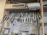 a lot of tools hanging on a rack in a garage