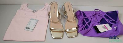 three pairs of shoes and a bag sitting on a table
