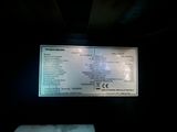 a picture of a large screen with information on it in a dark room
