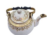 an image of a white tea pot with gold trimmings and a bow on top