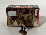 a small toy soldier standing next to a box