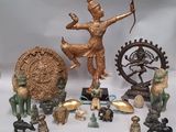 many different statues and figurines displayed on a white surface