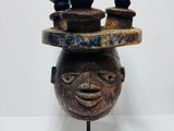 an image of a sculpture of a man ' s head with bowls on it