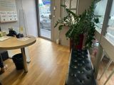 une femme assise à une table, avec une plante en pot