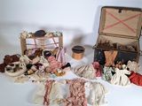 many different types of dolls in a suitcase on a table