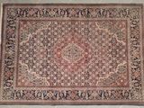 an antique persian rug with a medallion design on a white background