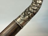 a close up of a metal object on a wooden stick