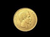 a close up of a gold coin on a black background