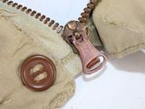 a close up of a zipper with a button on it