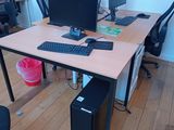 a computer desk with two monitors and a keyboard on it