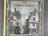 un vieux livre avec, au milieu, une image représentant une rue