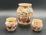 three vases sitting next to each other on a table