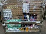 a large metal cage with a bunch of items inside of it