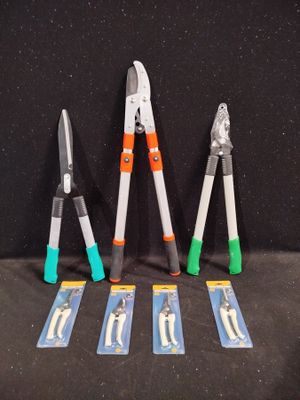 four different types of pliers are lined up on a black surface