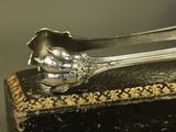 a silver spoon sitting on top of a black box