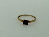 an image of a gold ring with a garnetite stone