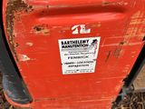a red trash can that has a sticker on it
