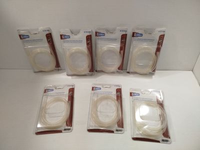 six tailles différentes de fils à coudre dans des sachets en plastique, posés sur une surface blanche