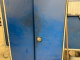 a blue refrigerator that is sitting in a garage