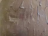 a close up of a piece of metal that has some paint on it