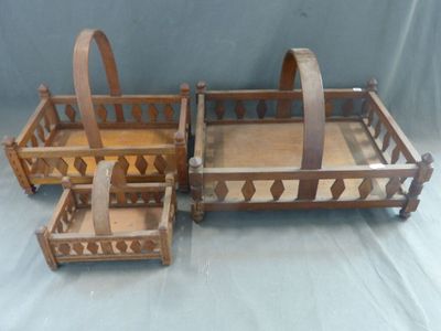 trois paniers en bois munis d'anses, posés sur une table