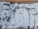 a cardboard box filled with a bunch of white shirts
