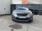 grey car parked in front of a building in front of a building