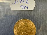 a close up of a gold coin with a label on it