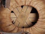 a close up of a baseball glove with a hole in it