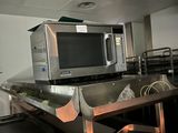 a microwave sitting on top of a counter in a kitchen