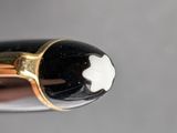 a close up of a pen with a white flower on it