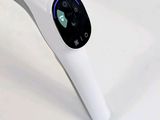 a white electric toothbrush sitting on a table next to a toothbrush