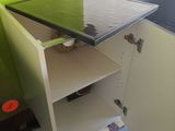 a small table with a glass top in the corner of a room