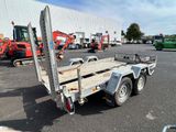 a trailer with a flat bed in the middle of a parking lot
