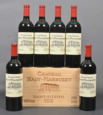 six bottles of red wine in a wooden crate on a table