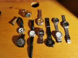 a lot of watches that are on a wooden table
