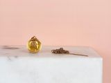 the gold ball is sitting on top of a white marble block