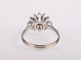 a close up of a silver ring with a flower design on it