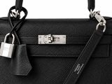 a close up of a black purse with a padlock on it