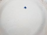 a white plate with a blue bird on it