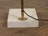 a lamp that is on a marble block on the floor