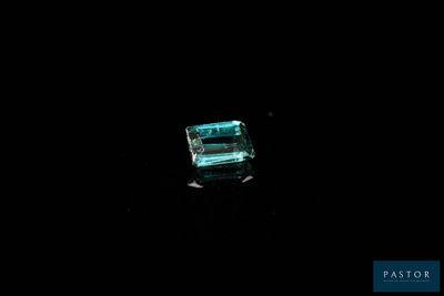 a green emerald stone on a black background
