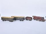 several toy trains are lined up in a row on a white surface
