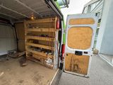 a white van that has some shelves in the back of it